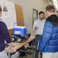 group of people listening to a senior project